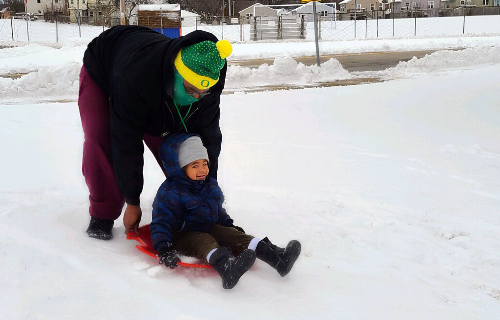 Father and son on the sledding hill
